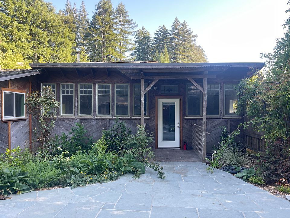View from the patio to the front door (living room is the 6 window to the left of the door... kitchen is the 3 windows on the right.)