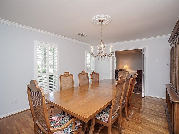 The formal living room is being used as the dining room as there is a lot of room for our large table and china cabinet. Love the shutters on the front windows that bring such a classy touch