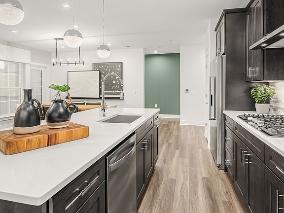Gourmet Kitchen with an Oversized Island and Stainless Steel Appliances