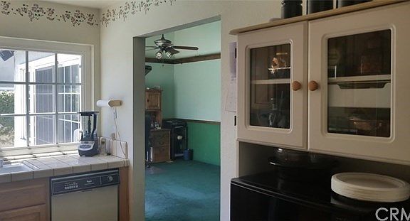 The kitchen looks into the family room and out into the backyard.