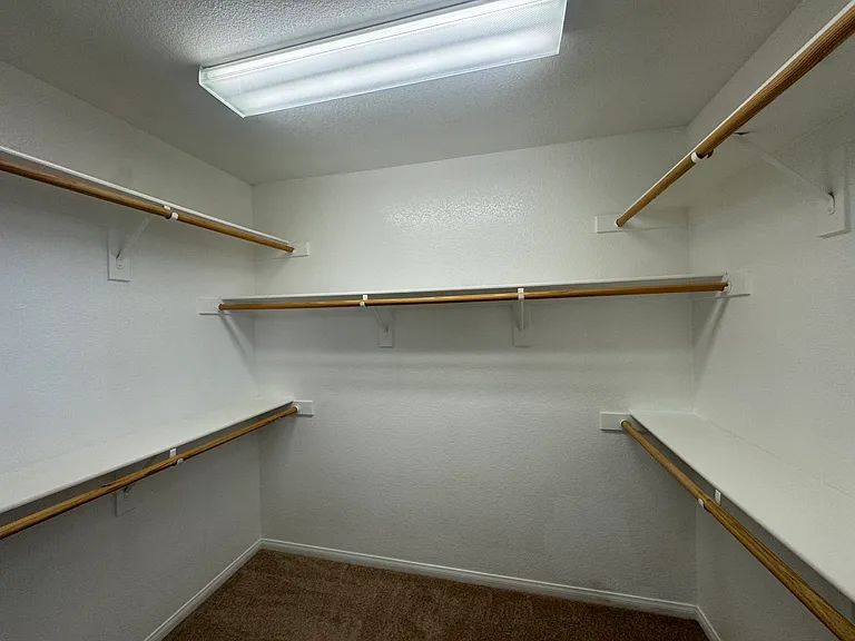 Primary bedroom walk-in closets