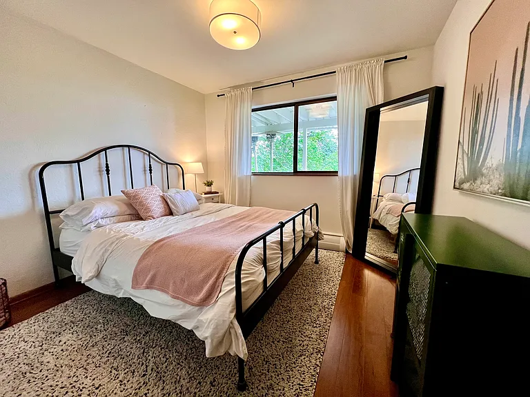 One of two lower-level bedrooms with a queen bed and long closet along with peek-a-boo views of the lake.