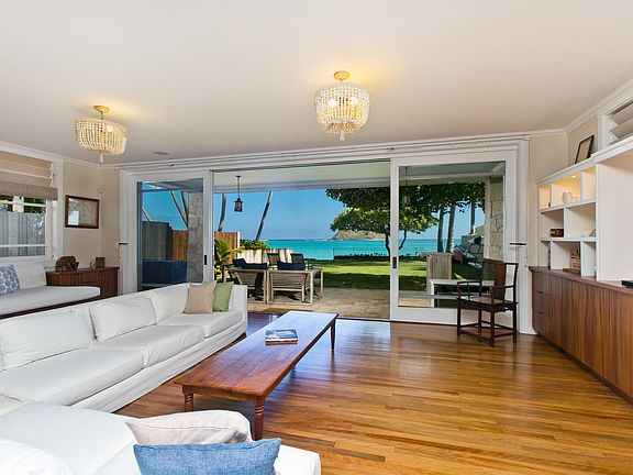 Spacious living room looking out to the back yard and to the Mokulua Islands