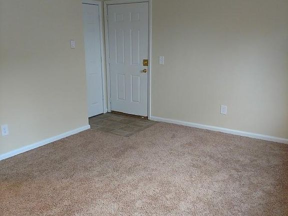 Front door into living room and closet space