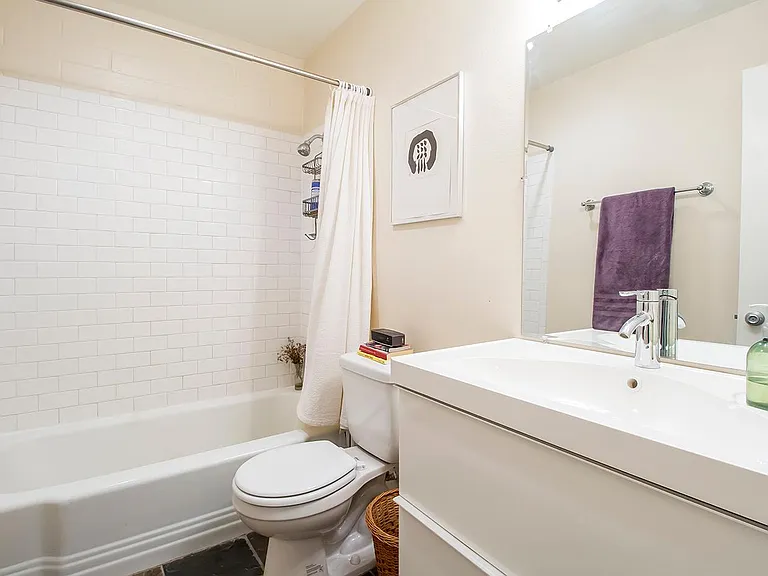 Ikea bathroom sinks, slate floors, bathtubs.