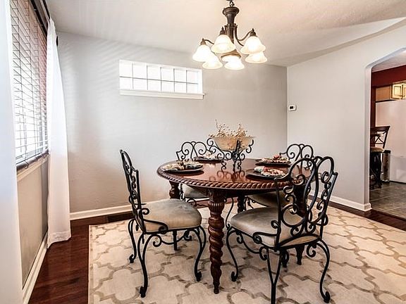 Freshly painted Dining Room with hardwood floors and glass block window.