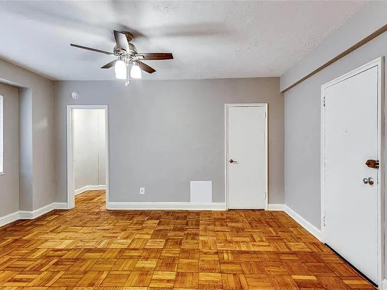 Renovated studio apartment with ceiling fan and parquet hardwood floors