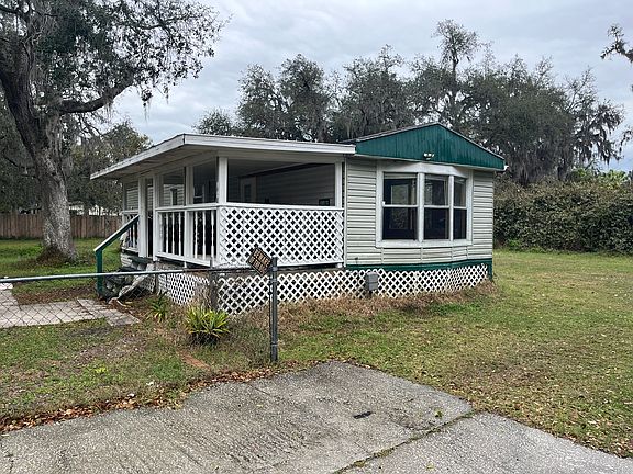 A view of the back porch with a fenced in back yard. Room for a garden. Private and at the end of the road.