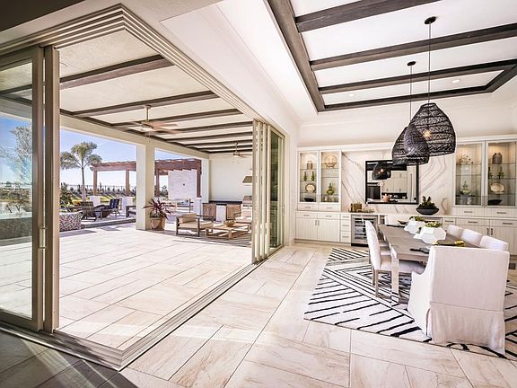 Casual dining area includes two beverage refrigerators and a 90-degree corner sliding door