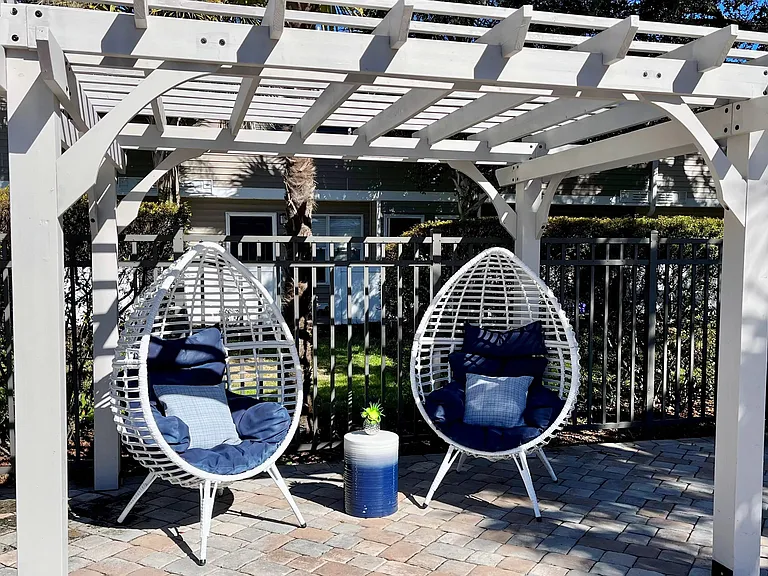 Relax and find tranquility under our poolside pergola retreat.