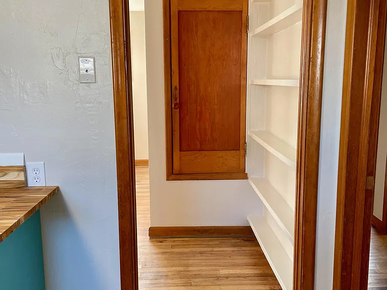 Kitchen towards Family Room, built in shelves, and classic storage closet