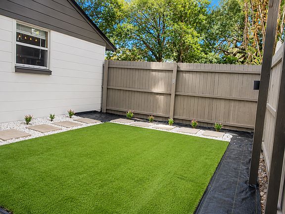 Private fenced yard with low maintenance turf.