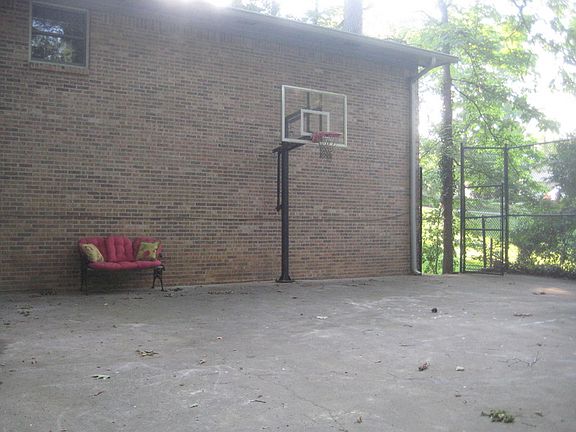 Back Basketball Court
						:
						A fenced dog kennel is to the left under the deck.