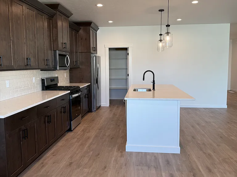 Kitchen has large island and tons of counter space. Fridge included.