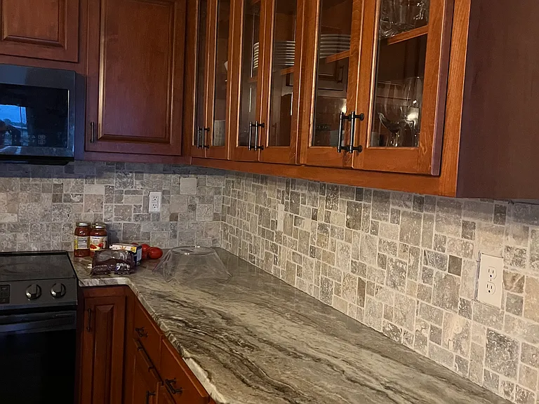 This photo shows the rustic hand tiled backsplash and the grain in the Colombian granite.