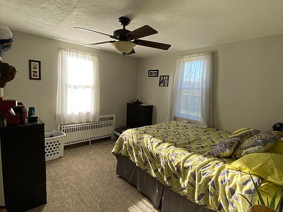 Large guest Bedroom with two windows.