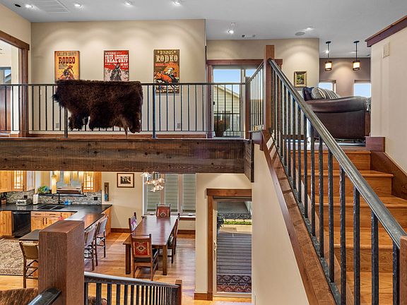 Open floor plan with extensive wood, iron and glass.