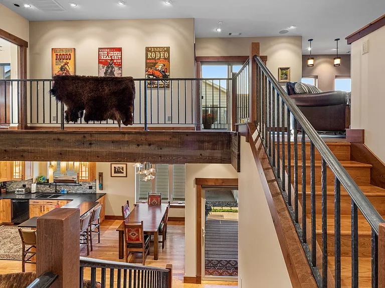 Open floor plan with extensive wood, iron and glass.