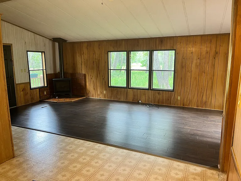 living room (pictured propane stove later replaced with wood-burning stove)
