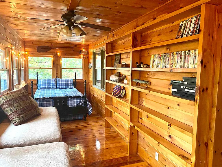 Enclosed "sleeper porch" with one full sized bed & two twin beds.