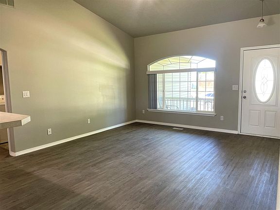 Living Room with beautiful, large window for natural light and cove ceilings.