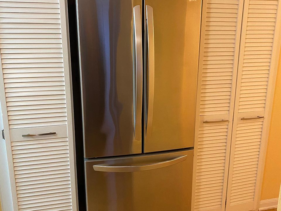 Newer fridge in the hall next to the kitchen + additional storage