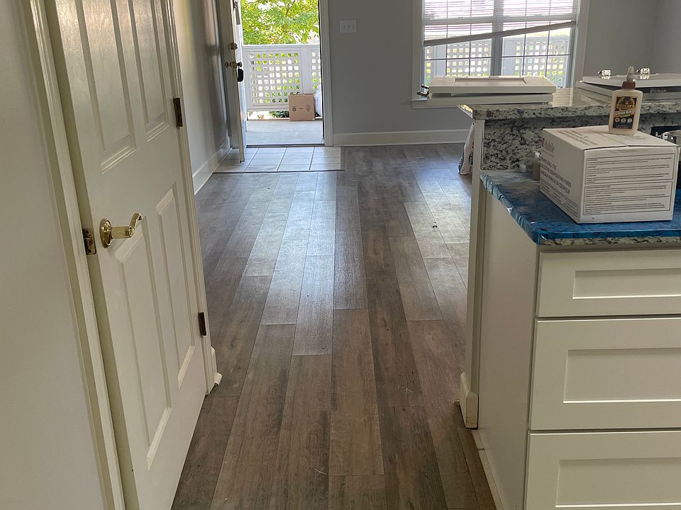 View of kitchen and open living room to the front door