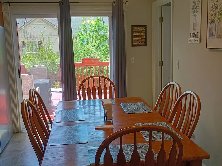 The dining area sits adjacent to the kitchen and seats six people. From this space, you can step directly onto the deck at the back of the house.