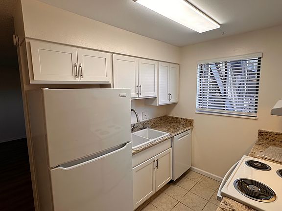 Kitchen with new cabinets, appliances, sinks, granite countertops, pulls, blinds, paint, switches and outlets.