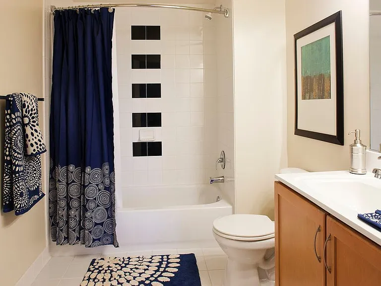 Bath with white countertop and tiled tub