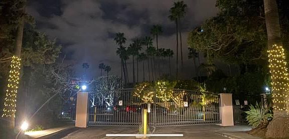 Main gated entrance to Brentwood Sunset at night