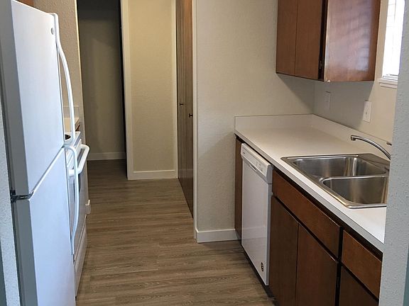 Kitchen with new paint, flooring, countertops, sink, faucet, garbage disposal, dishwasher, lights and blinds. The washer and dryer are on the right behind the acordian doors you can kinda see
