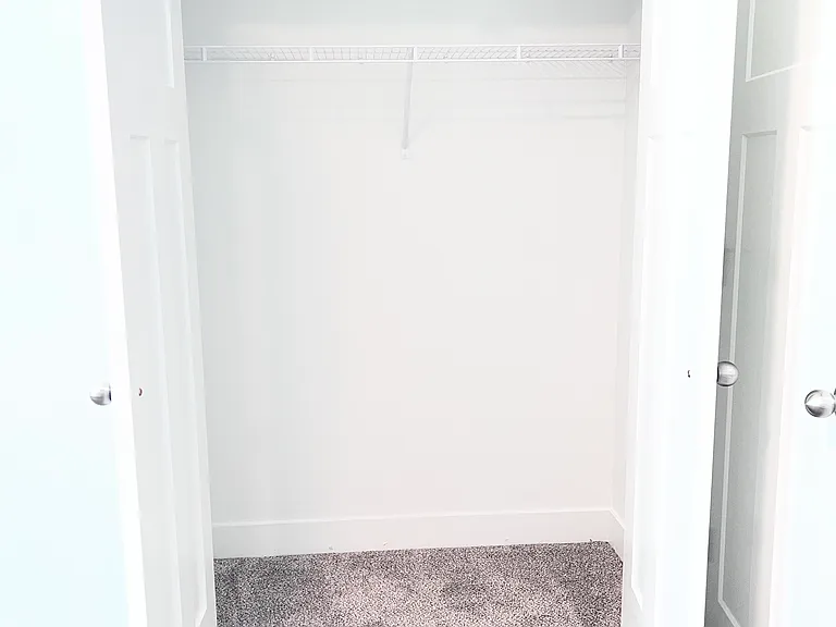 First bedroom closet with french doors