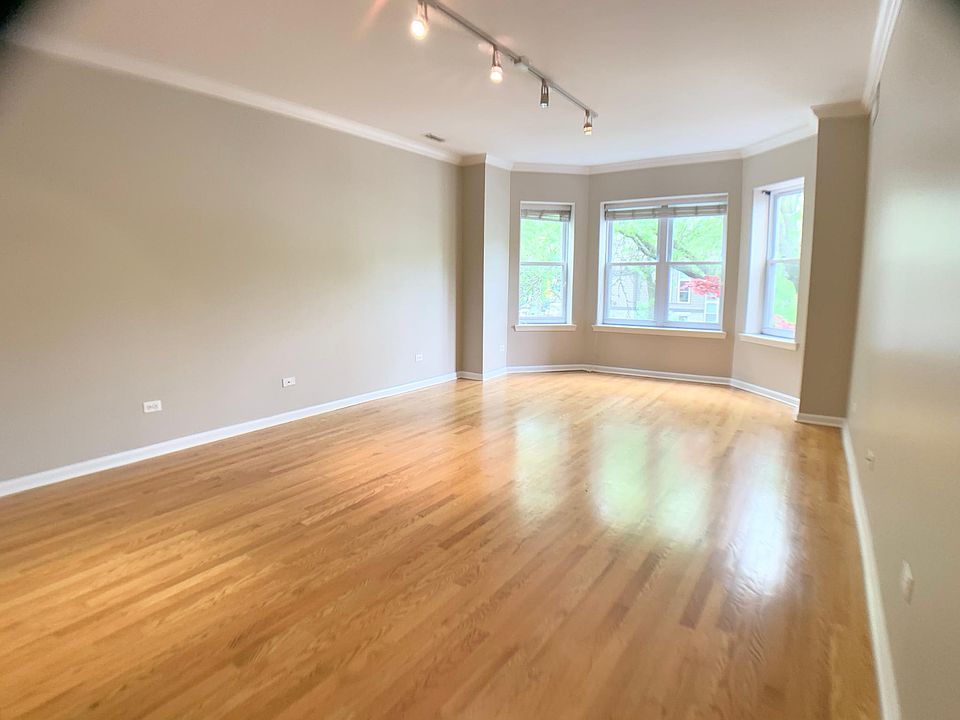 Living room 16-6 x 13-0 and large Bay Windows and hardwood flooring.