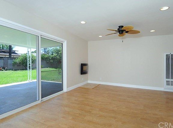 Another view of the living room with recessed lighting & ceiling fan