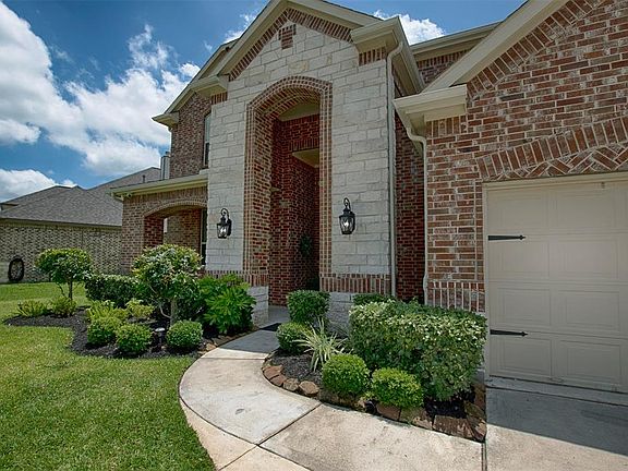 Lovely landscaping and gorgeous limestone accents provide an inviting entrance to the home.