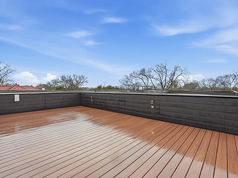 Spacious rooftop deck with skyline views. Perfect for relaxing or entertaining.