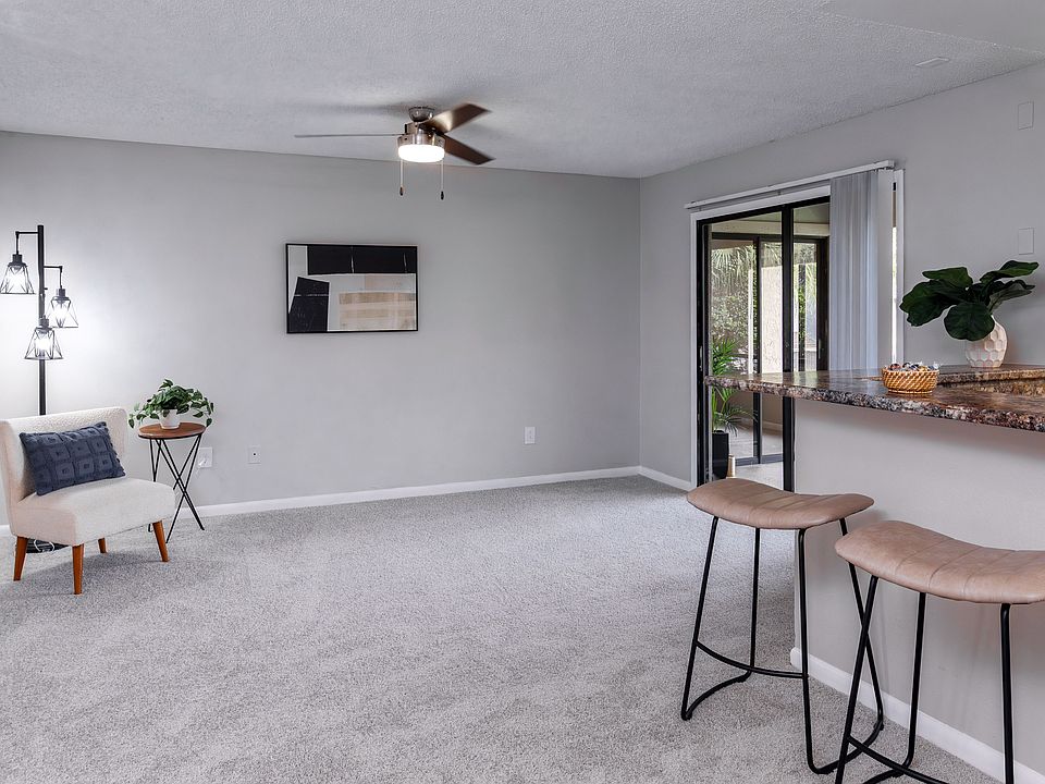 Enjoy the comfort of a spacious, open living featuring plush carpeting, a breakfast bar, and direct access to a screened-in patio.