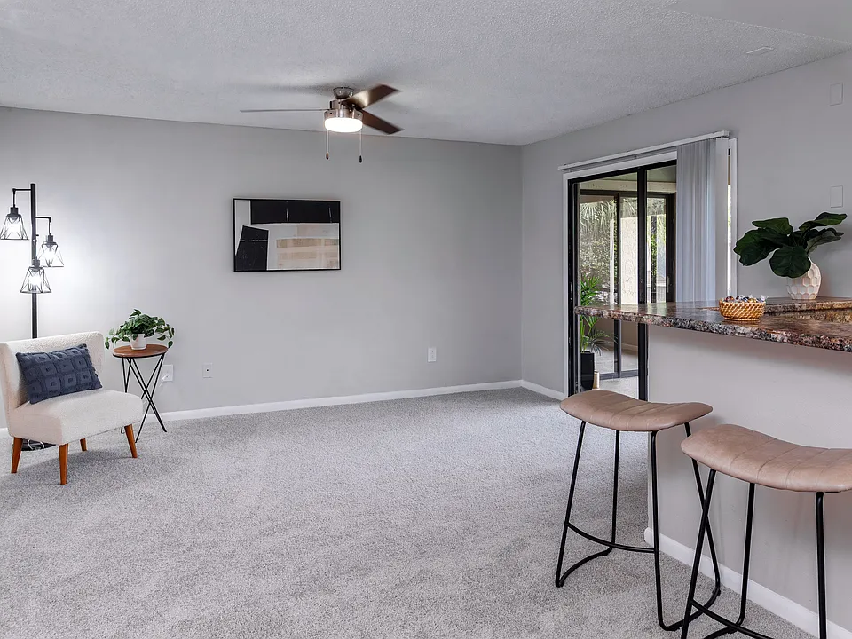 Enjoy the comfort of a spacious, open living featuring plush carpeting, a breakfast bar, and direct access to a screened-in patio.