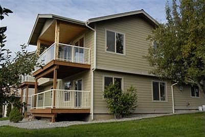 Large covered trek decks plumbed for natural gas with glass railing.