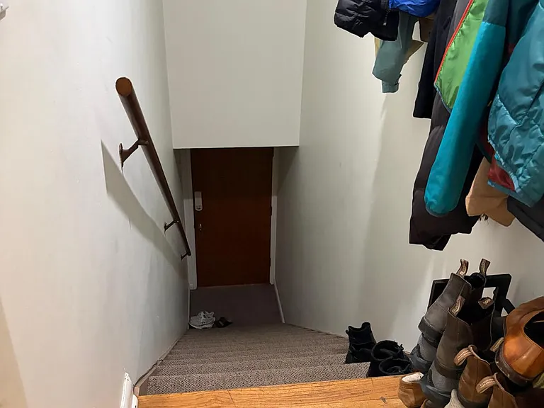 Stairs up to the apartment (separated with another door upstairs)