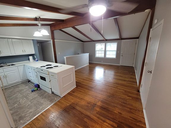 Spacious open kitchen and living room area, stairs to. tehlower level