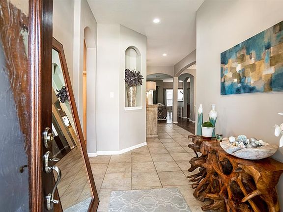 LOOK AT THAT BEAUTIFUL OPEN-CONCEPT! From the moment you walk in you are greeted with stunning neutral gray paint and curved architectural walkways throughout the entire home!