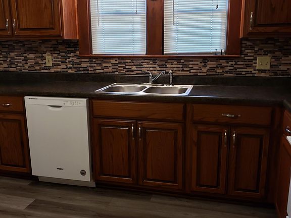 Remodeled kitchen with stove, dishwasher, and refrigerator