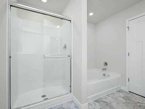 The master bathroom has a step in shower and a soaking tub.