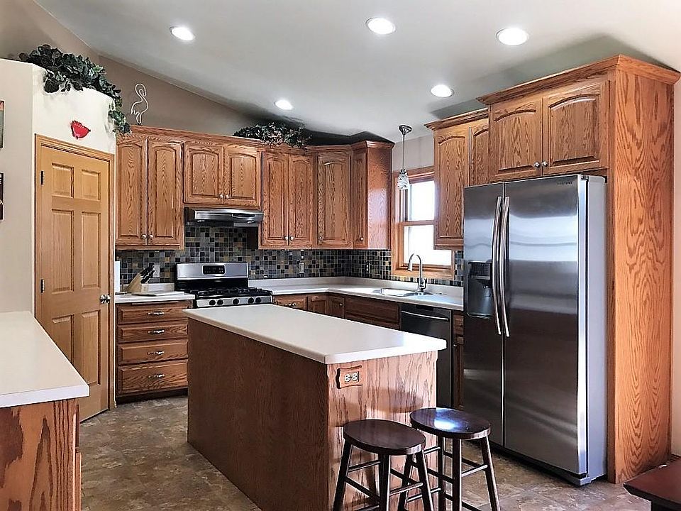 Gourmet kitchen with large pantry, stainless appliances, and