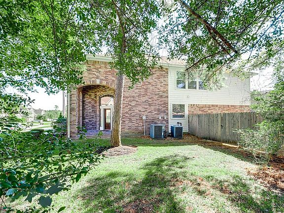 Side view of the home from the wooded green belt.