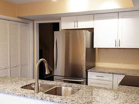 Eat-In Kitchen w/Granite Counters, White Cabinets & Stainless-Steel Appliances