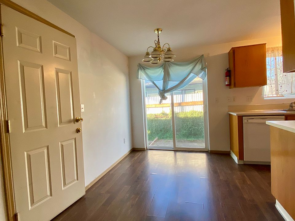 Nook with garage/storage door to the left and kitchen to the right