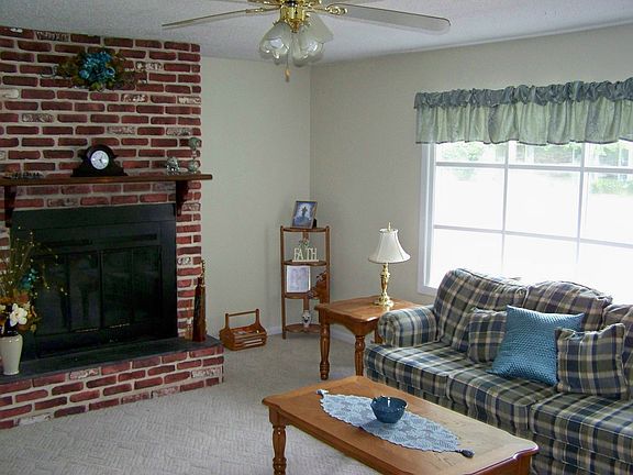 Living room with fireplace and bay window